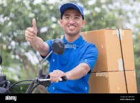 delivery-man-send-order-parcel-with-motors-and-thumb-up-2G0YD0C.webp