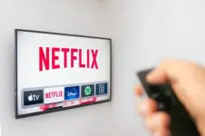 a-person-holds-an-apple-tv-remote-using-the-new-netflix-app-with-a-hand-netflix-dominates.webp