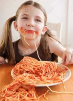 child-eating-spaghetti-XA5DG9.webp