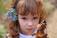 cute-girl-with-horse-toy.webp