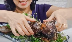 Pretty-Vietnamese-woman-eats-whole-roasted-domestic-cat-and-smiles.webp